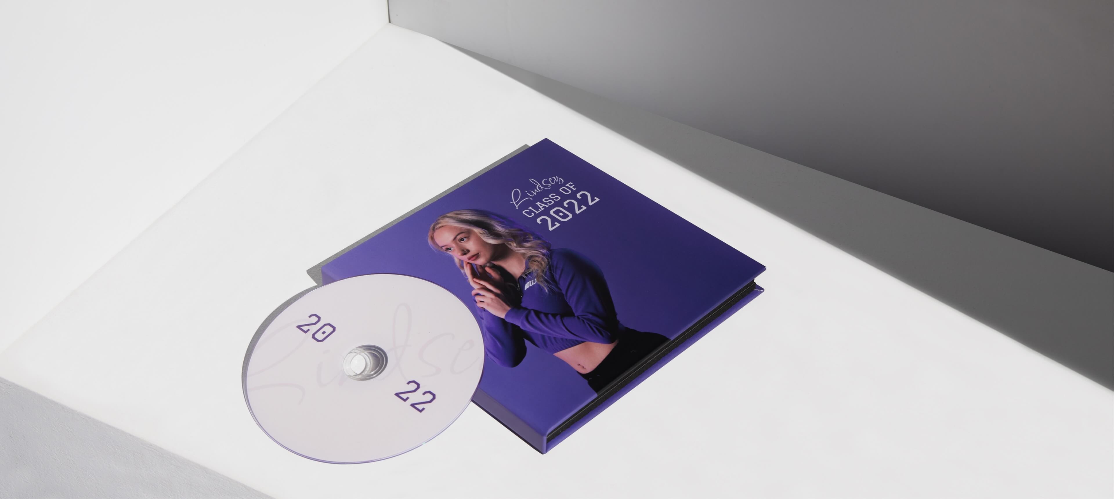 a dvd case set on a white table showing a woman in a purple sweater